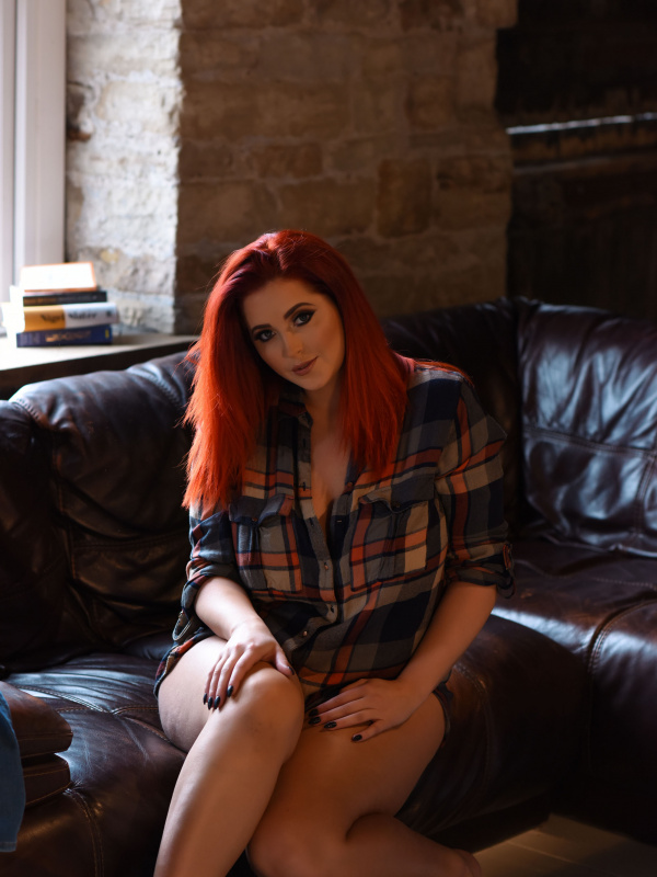 Lucy V strips on a couch